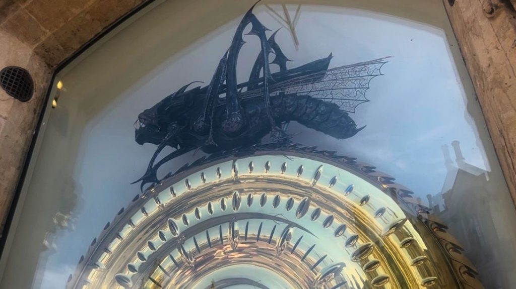 Giant metal grasshopper onto of Corpus Clock in Cambridge